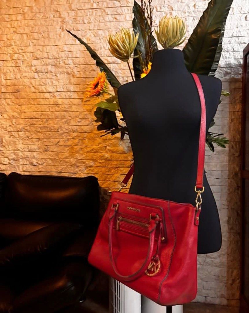 Michael Kors Red Handbag (Category: Luxury Bags & Wallets) located in Quezon City. Submitted by mvdeclutter (Listing ID 1401834850, Image 3). Description: - Red Michael Kors handbag - Top handle and detachable shoulder strap - Front zipper pocket - Gold-tone MK logo charm - Gold-tone hardware - Structured design.