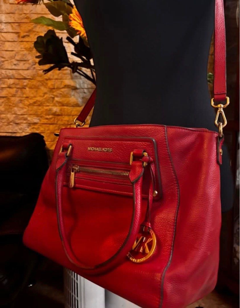 Michael Kors Red Handbag (Category: Luxury Bags & Wallets) located in Quezon City. Submitted by mvdeclutter (Listing ID 1401834850, Image 2). Description: - Red Michael Kors handbag - Top handle and detachable shoulder strap - Front zipper pocket - Gold-tone MK logo charm - Gold-tone hardware - Structured design.