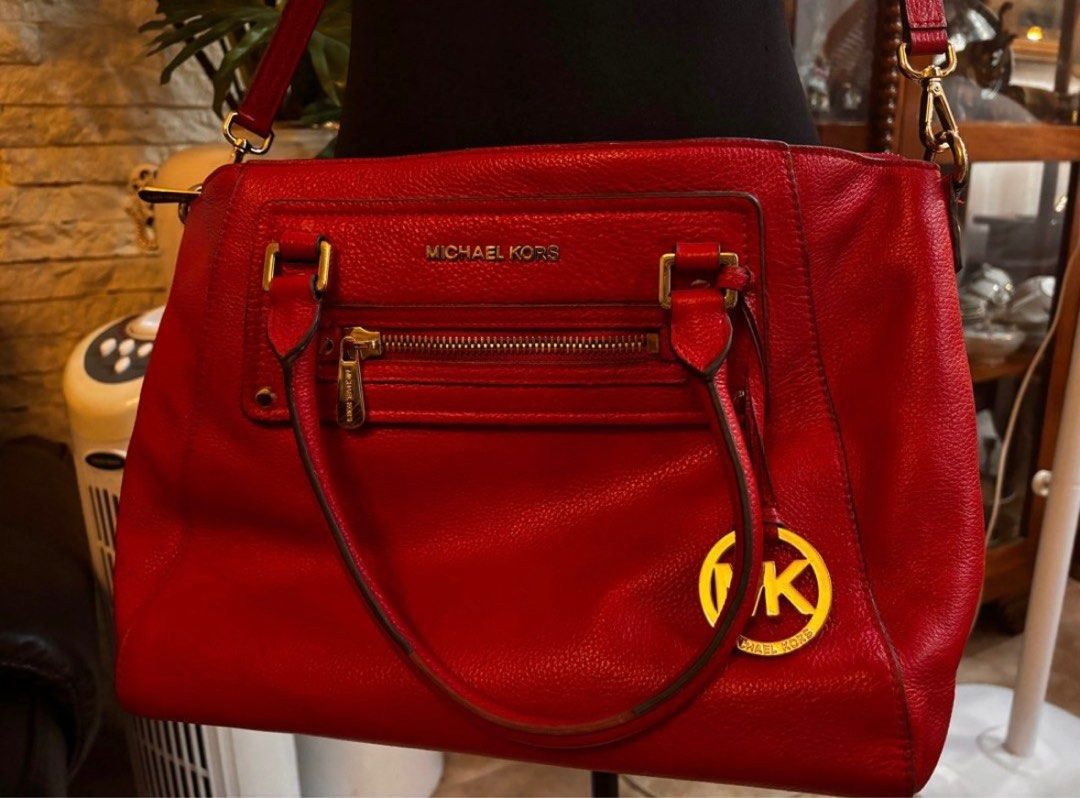 Michael Kors Red Handbag (Category: Luxury Bags & Wallets) located in Quezon City. Submitted by mvdeclutter (Listing ID 1401834850, Image 1). Description: - Red Michael Kors handbag - Top handle and detachable shoulder strap - Front zipper pocket - Gold-tone MK logo charm - Gold-tone hardware - Structured design.