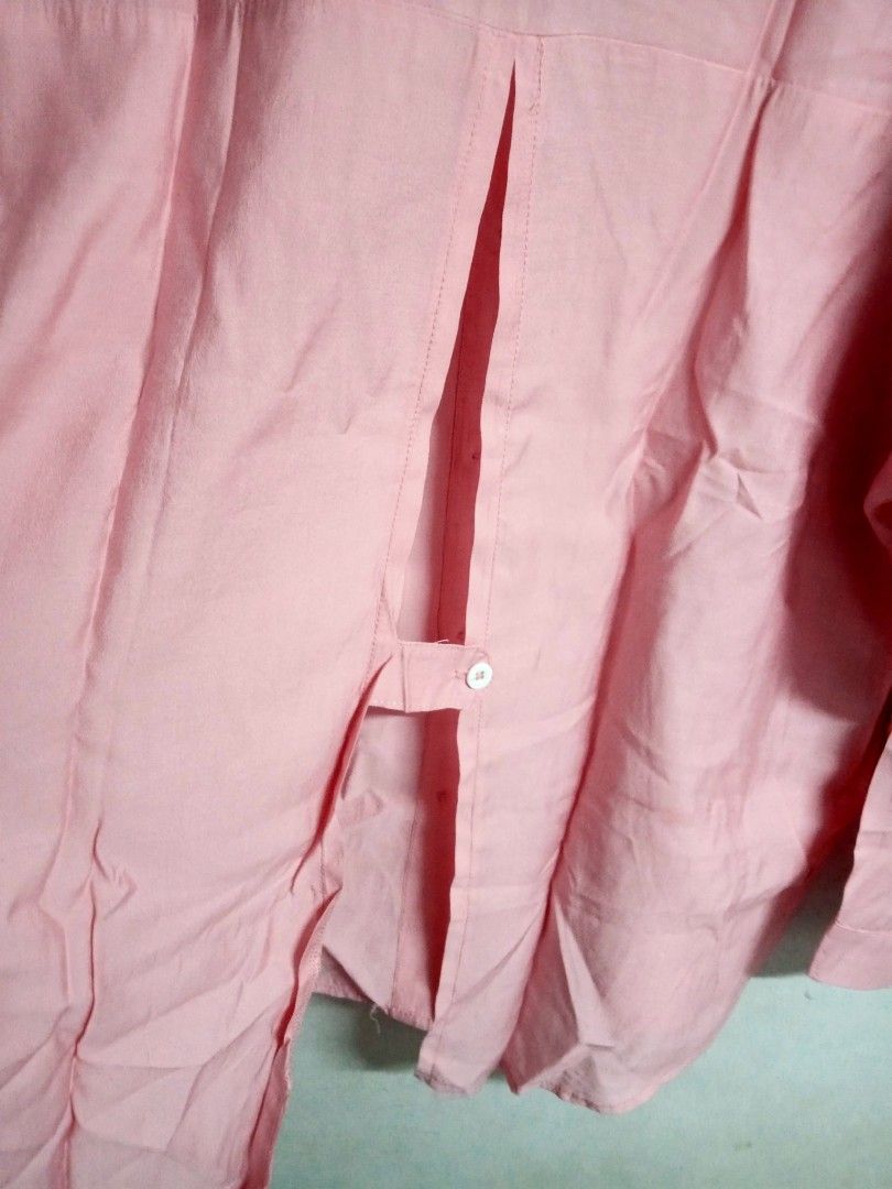 Pink Button-Down Blouse (Category: Blouses) located in Bulacan. Submitted by ely46 (Listing ID 1401845855, Image 3). Description: - Pink button-down blouse - Collared neckline - Long sleeves - Relaxed fit - Unique split back detail with button closure - Lightweight fabric - Versatile for various occasions.