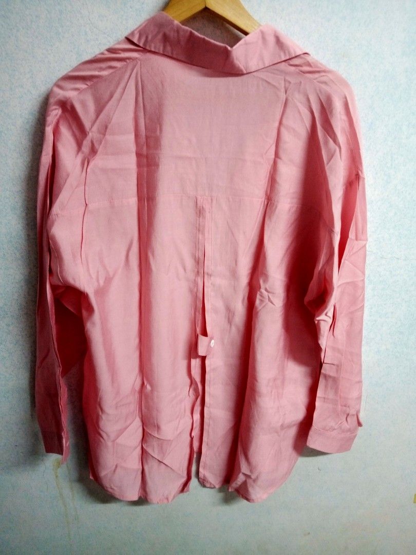 Pink Button-Down Blouse (Category: Blouses) located in Bulacan. Submitted by ely46 (Listing ID 1401845855, Image 2). Description: - Pink button-down blouse - Collared neckline - Long sleeves - Relaxed fit - Unique split back detail with button closure - Lightweight fabric - Versatile for various occasions.