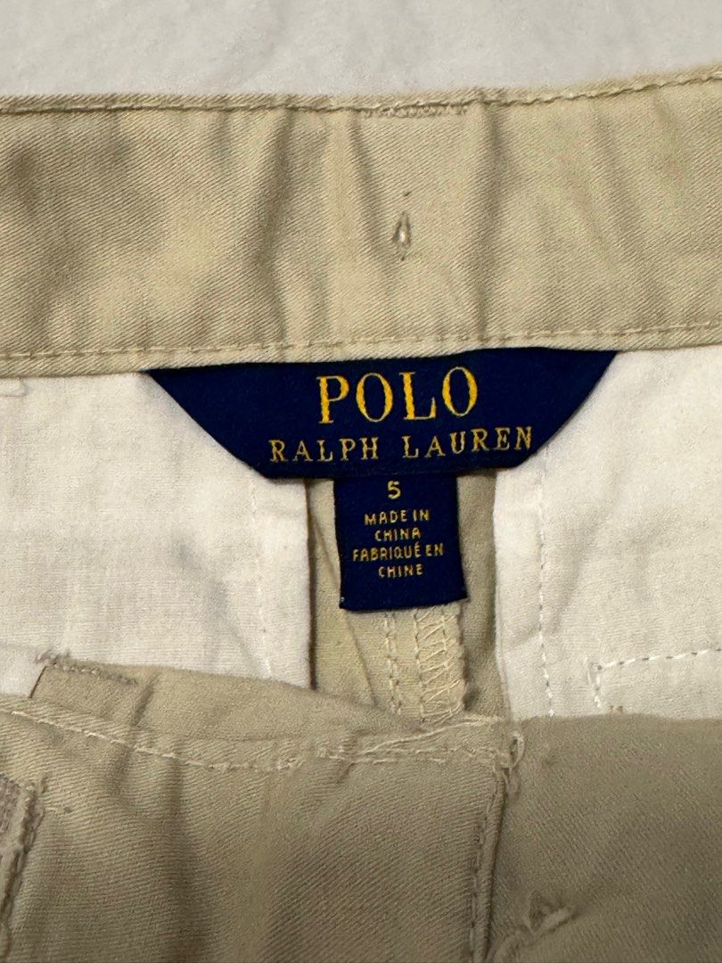 Polo Ralph Lauren Cargo Shorts - Size 5 (Category: Babies & Kids Fashion) located in San Ildefonso. Submitted by yeyely (Listing ID 1401737486, Image 2). Description: - Authentic Polo Ralph Lauren cargo shorts - Neutral beige color - Size 5 - Classic cargo design with multiple pockets - Button closures - Made in China - Perfect for everyday wear - Polo Ralph Lauren tag attached.