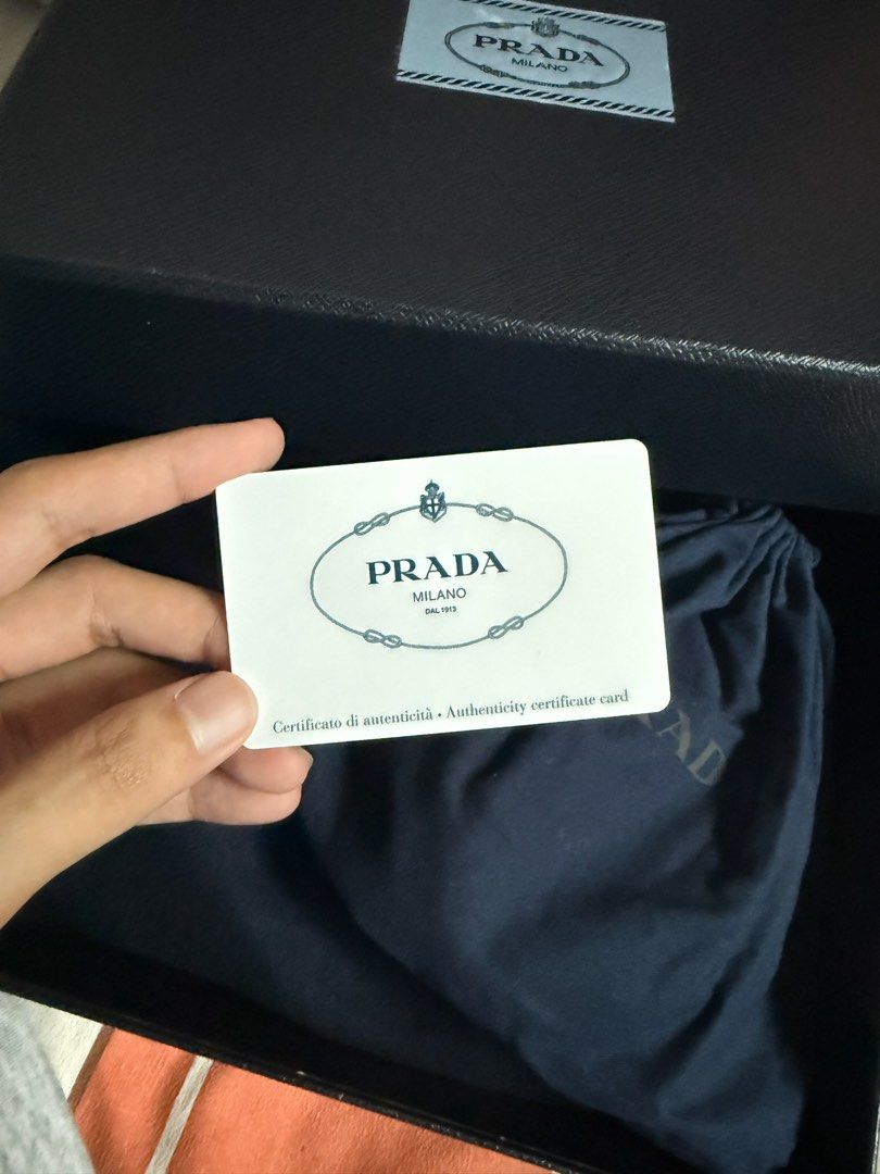 Prada Brique Crossbody Bag (Category: Luxury Bags & Wallets) located in Paranaque City. Submitted by kckvr (Listing ID 1401819311, Image 3). Description: - Authentic Prada crossbody bag - Color: Black - Includes detachable coin purse - Adjustable black strap - Silver-tone hardware - Rectangular shape with zip closure - Prada logo visible - Comes with original box, dust bag, and authenticity card - Near mint condition - Bought this in Collins St. 