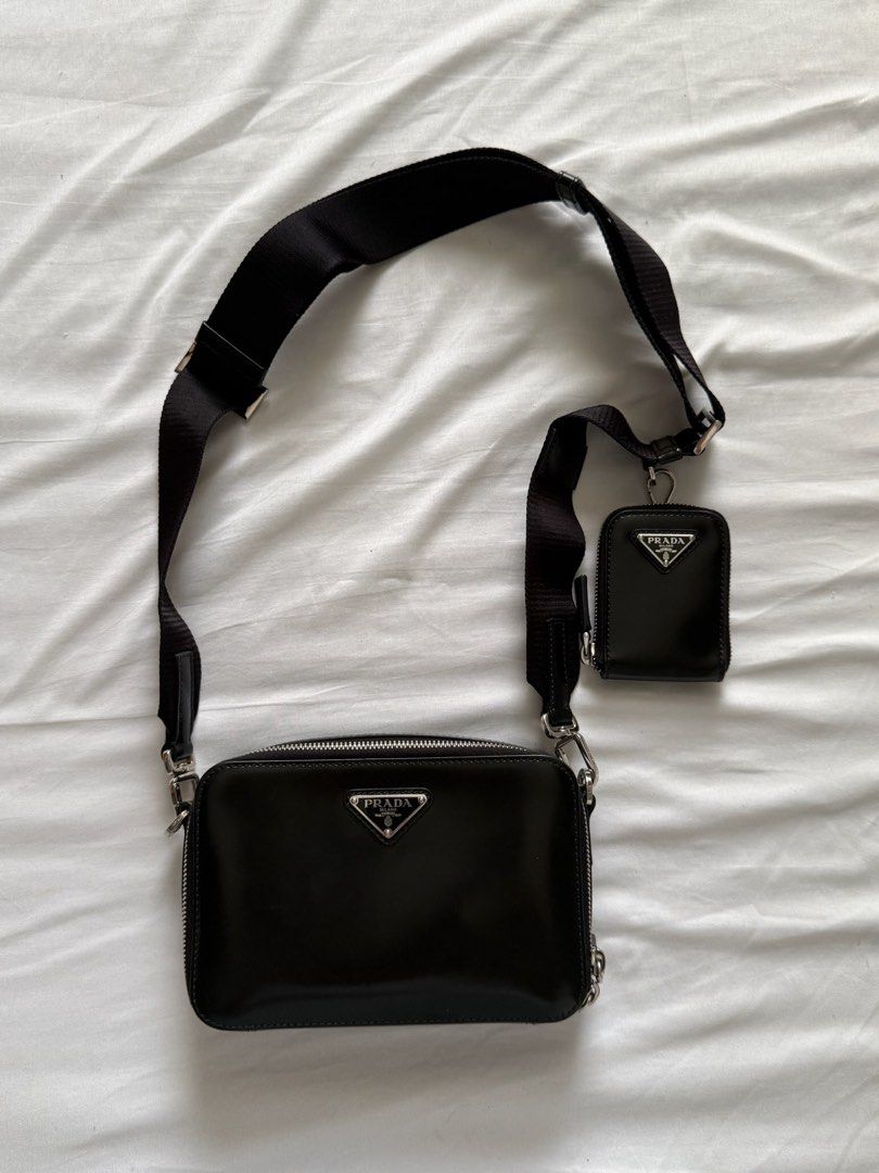 Prada Brique Crossbody Bag (Category: Luxury Bags & Wallets) located in Paranaque City. Submitted by kckvr (Listing ID 1401819311, Image 1). Description: - Authentic Prada crossbody bag - Color: Black - Includes detachable coin purse - Adjustable black strap - Silver-tone hardware - Rectangular shape with zip closure - Prada logo visible - Comes with original box, dust bag, and authenticity card - Near mint condition - Bought this in Collins St. 