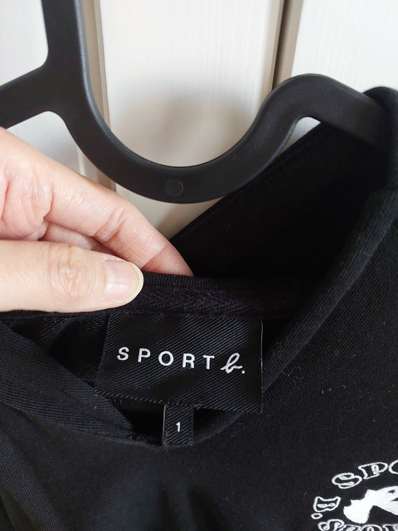 Sport B. Black Hoodie (Category: Hoodies) located in Mandaluyong City. Submitted by declutterwithkinah (Listing ID 1401727335, Image 2). Description: - Sport B black hoodie - Round logo on the chest - Side pocket - Comfortable fabric - Brand tag visible - Ideal for casual wear - Size: 1 - original bought from Sport b Podium (bought at around php6000) - used less than 5x.