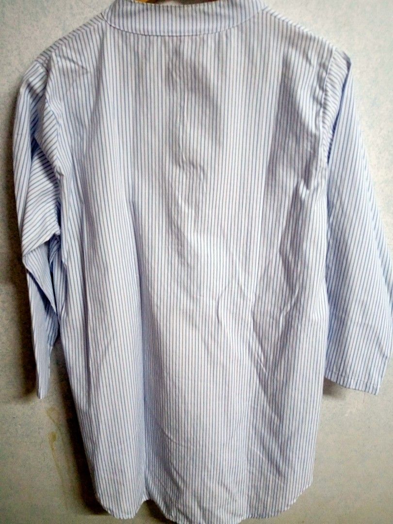 Striped Blouse (Category: Blouses) located in Bulacan. Submitted by ely46 (Listing ID 1401846516, Image 2). Description: Blouse features a classic striped pattern in light blue and white. It has a mandarin collar and a button-down placket. The sleeves are three-quarter length. It has a relaxed fit and a slightly longer back hem..