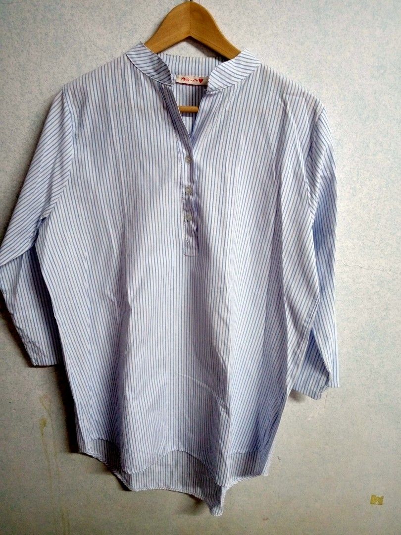 Striped Blouse (Category: Blouses) located in Bulacan. Submitted by ely46 (Listing ID 1401846516, Image 1). Description: Blouse features a classic striped pattern in light blue and white. It has a mandarin collar and a button-down placket. The sleeves are three-quarter length. It has a relaxed fit and a slightly longer back hem..