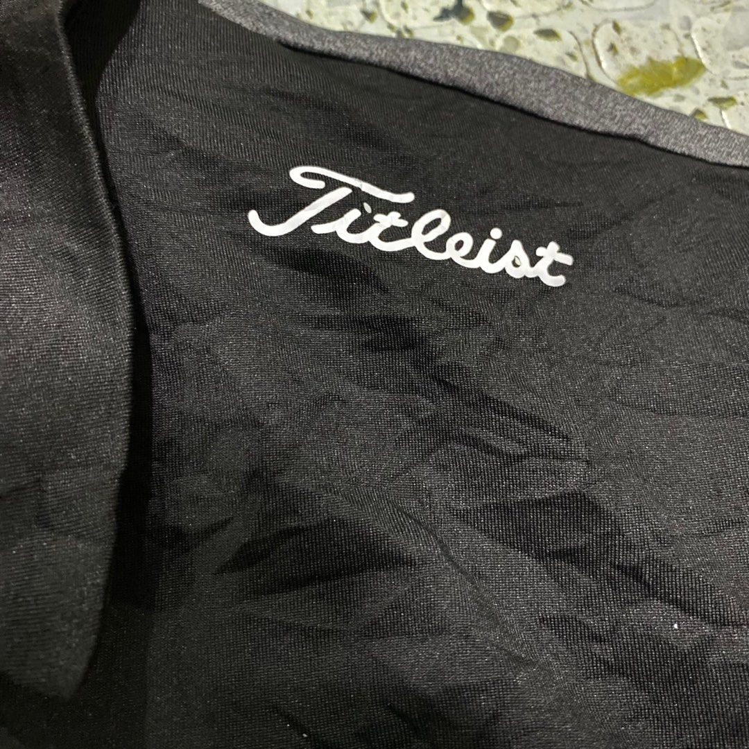 Titleist Golf Polo Shirt - Large (Category: Tshirts & Polo Shirts ) located in Cebu City. Submitted by vast_trese.13 (Listing ID 1401905142, Image 3). Description: - Titleist golf polo shirt - Size: Large - Color block design: black collar and sleeves, white chest stripe, gray body - Titleist logo on collar - Classic polo collar and button closure.