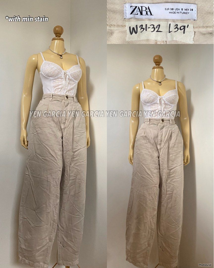 Zara Beige Wide Leg Pants (Category: Other Bottoms) located in Naga. Submitted by jamilaph (Listing ID 1401774926, Image 1). Description: - Zara beige wide-leg pants - High-waisted - Relaxed fit - Size: W31-32, L39 - Button and zipper closure - Minor stain present - Made in Turkey.