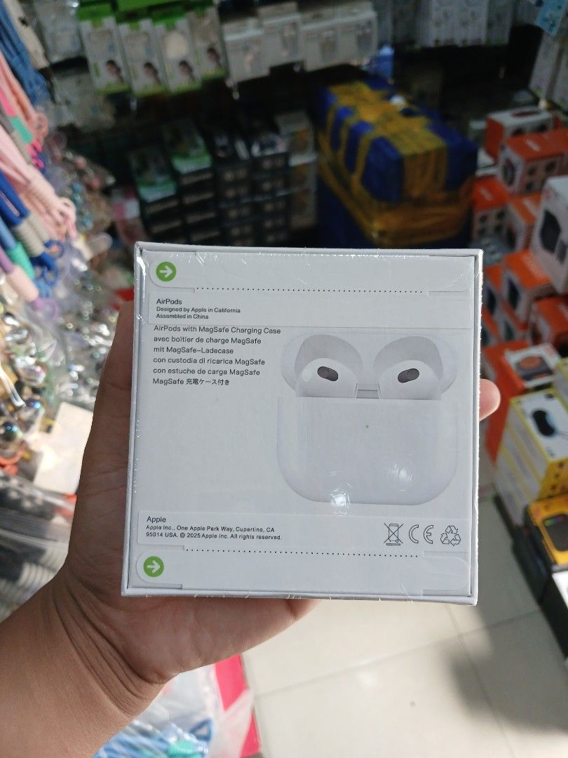 AirPods Gen 3with MagSafe Charging Case (Category: Earphones) located in Manila. Submitted by nhh_accessories (Listing ID 1405231476, Image 2). Description: - Apple AirPods with MagSafe Charging Case - Includes AirPods and charging case - Color: White - Box features: - AirPods design - Charging case - Apple logo - Product information.