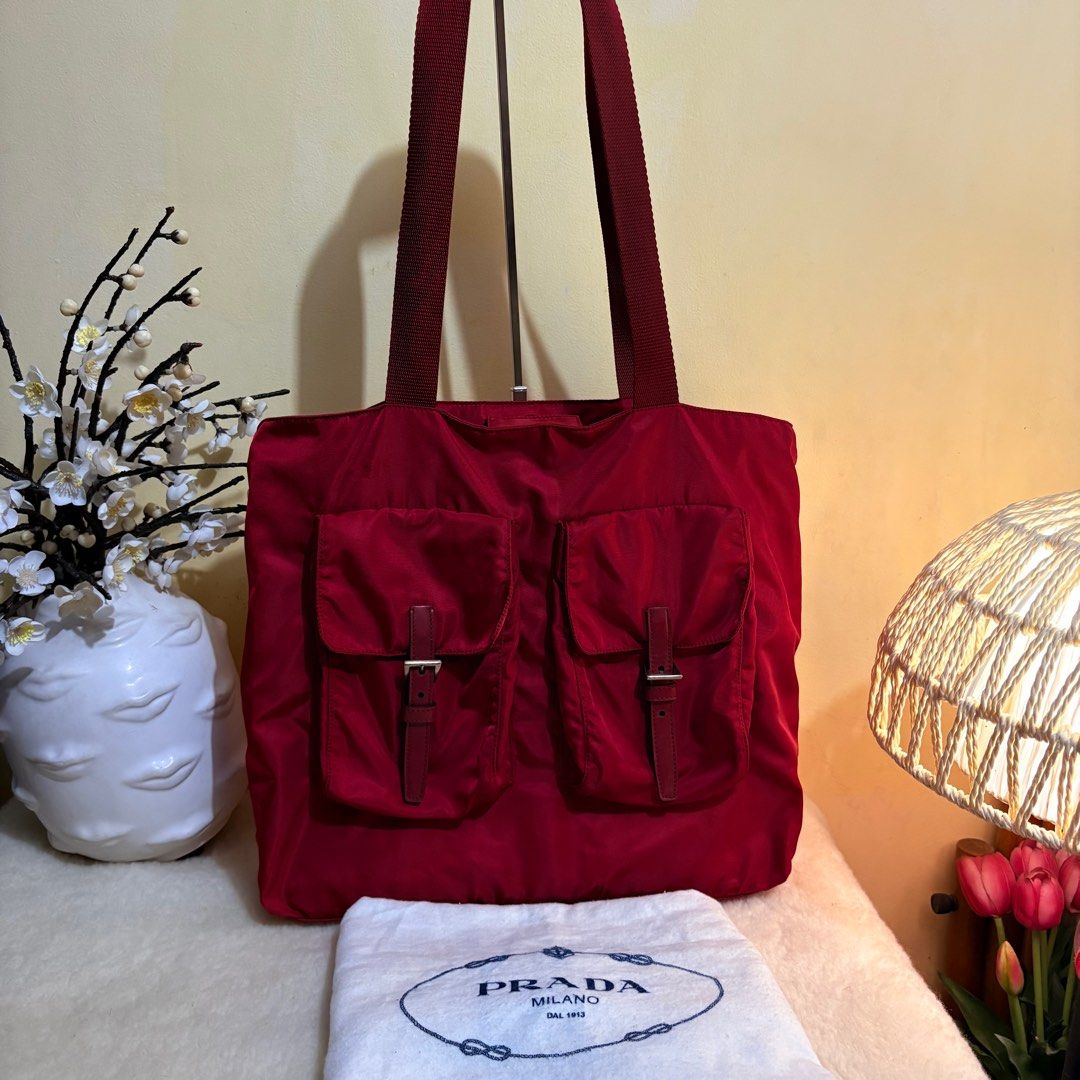 Authentic Prada Tessuto Nylon Cherry Red Two Front Pocket Side logo Tote Bag (Category: Luxury Bags & Wallets) located in Binangonan. Submitted by makoleksyon (Listing ID 1405325897, Image 2). Description: Excellent condition Like new No flaws Comes with dust bag Ganda ng kulay Bought in Japan Size: H-13 X W-15 inches 💯% Authentic Money back guarantee .