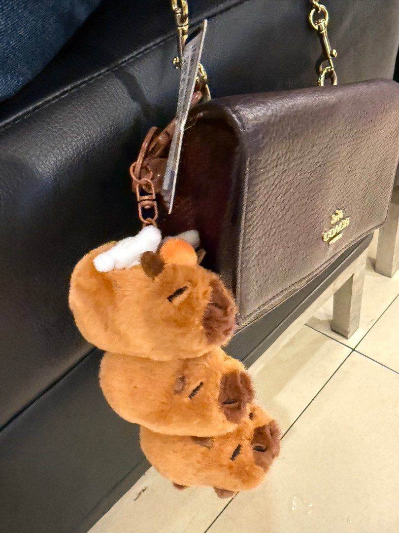 Capybara Plush Keychain (Category: Plushies & Soft Toys) located in Manila. Submitted by japanfindsbyaleja (Listing ID 1405329586, Image 1). Description: - Adorable capybara plush keychain - Features a stack of three capybaras - Includes a tag - Gold-colored chain - Perfect for bags or keys.