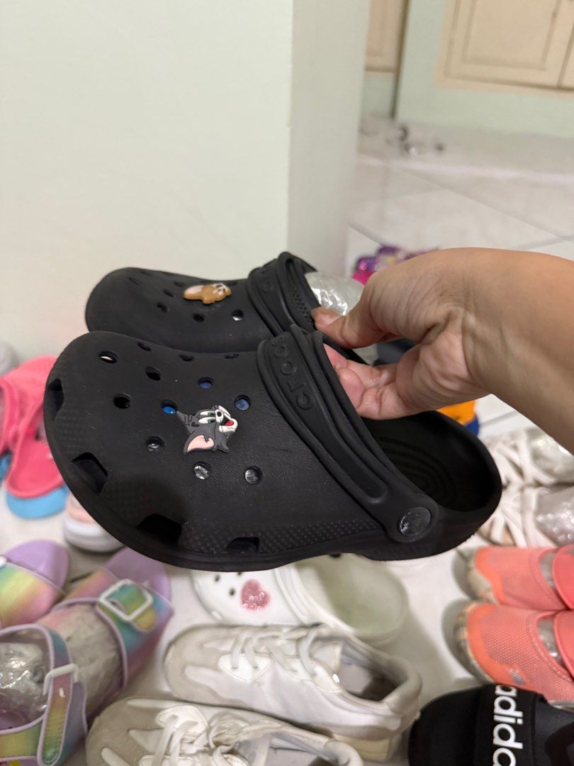 Crocs Black Clogs with Jibbitz (Category: Slippers and slides) located in Manila. Submitted by japanfindsbyaleja (Listing ID 1405329505, Image 1). Description: - Black Crocs clogs - Includes Tom & Jerry and sloth Jibbitz charms - Size not indicated.