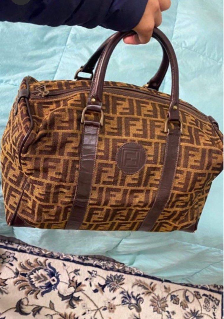 Fendi Boston Bag (Category: Luxury Bags & Wallets) located in Gapan. Submitted by Nutella2023 (Listing ID 1405201376, Image 1). Description: - Authentic Fendi Boston bag - Features the iconic FF logo pattern - Brown leather trim and handles - Zip closure - Leather logo patch on front - Medium size, ideal for everyday use - Minor wear on corners.