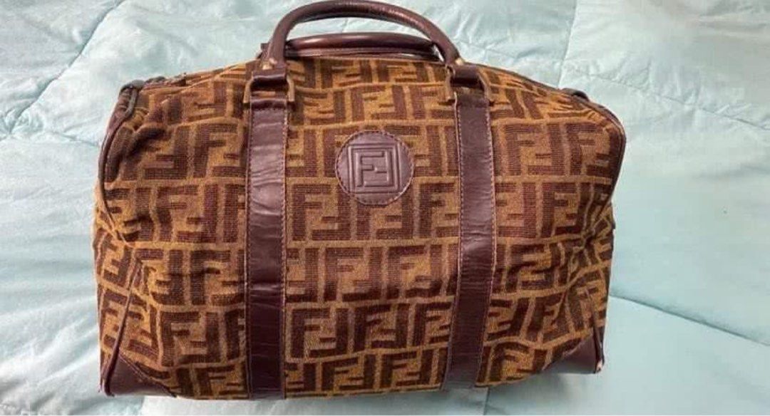 Fendi Boston Bag (Category: Luxury Bags & Wallets) located in Gapan. Submitted by Nutella2023 (Listing ID 1405201376, Image 2). Description: - Authentic Fendi Boston bag - Features the iconic FF logo pattern - Brown leather trim and handles - Zip closure - Leather logo patch on front - Medium size, ideal for everyday use - Minor wear on corners.