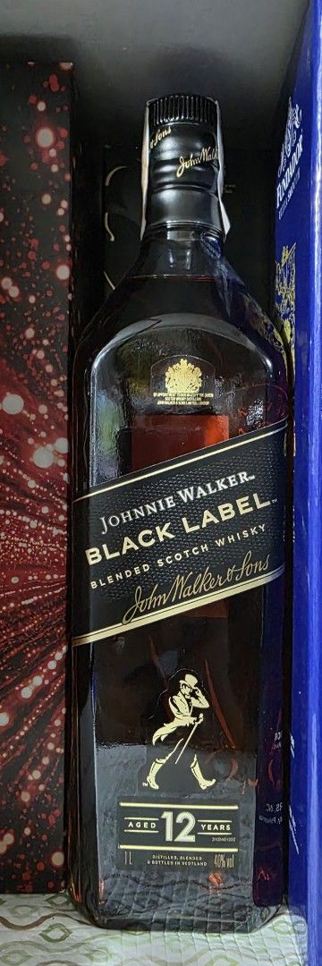 Johnnie Walker Black Label 12 Year Old (Category: Beverages) located in Imus. Submitted by my8th (Listing ID 1405340780, Image 1). Description: - Johnnie Walker Black Label - 12-year-old blended scotch whisky - Original packaging included - Features the iconic Johnnie Walker striding man logo - Black label with gold lettering - Includes a seal.