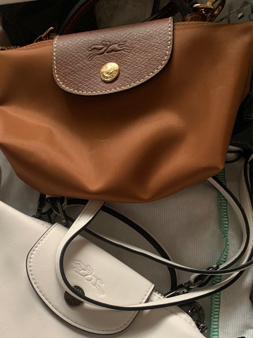 Authentic Longchamp Le Pliage Crossbody Bag (Category: Luxury Bags & Wallets) located in Manila. Submitted by leigh_dior (Listing ID 1405280393, Image 2). Description: - Two Longchamp Le Pliage Crossbody Bags - Colors: Tan with Brown Flap, White - Features: Flap Closure with Longchamp Logo, Chain Strap - Includes: Longchamp Dust Bag.