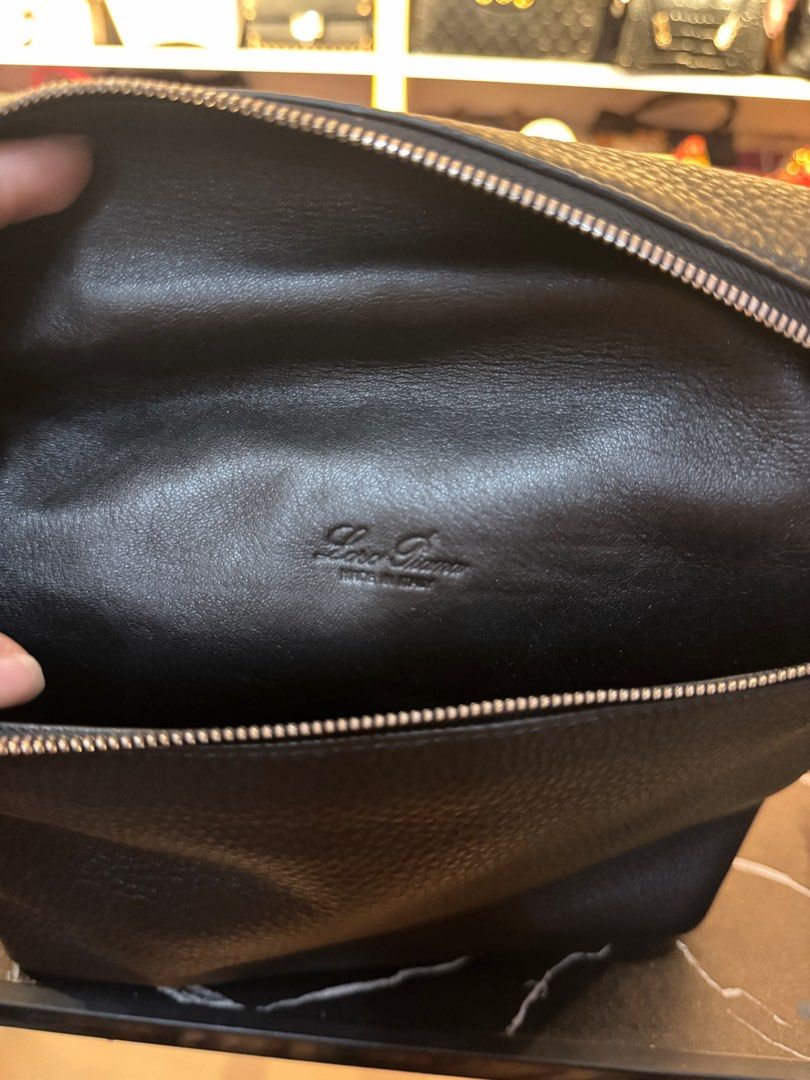 Loro Piana Black Leather Handbag (Category: Luxury Bags & Wallets) located in Rodriguez. Submitted by PrelovedbyMelz (Listing ID 1405219300, Image 2). Description: - Loro Piana black handbag - Structured, boxy design - Top handle - Made of textured leather - Leather interior - Zipper closure - Loro Piana logo visible inside - Classic and versatile.