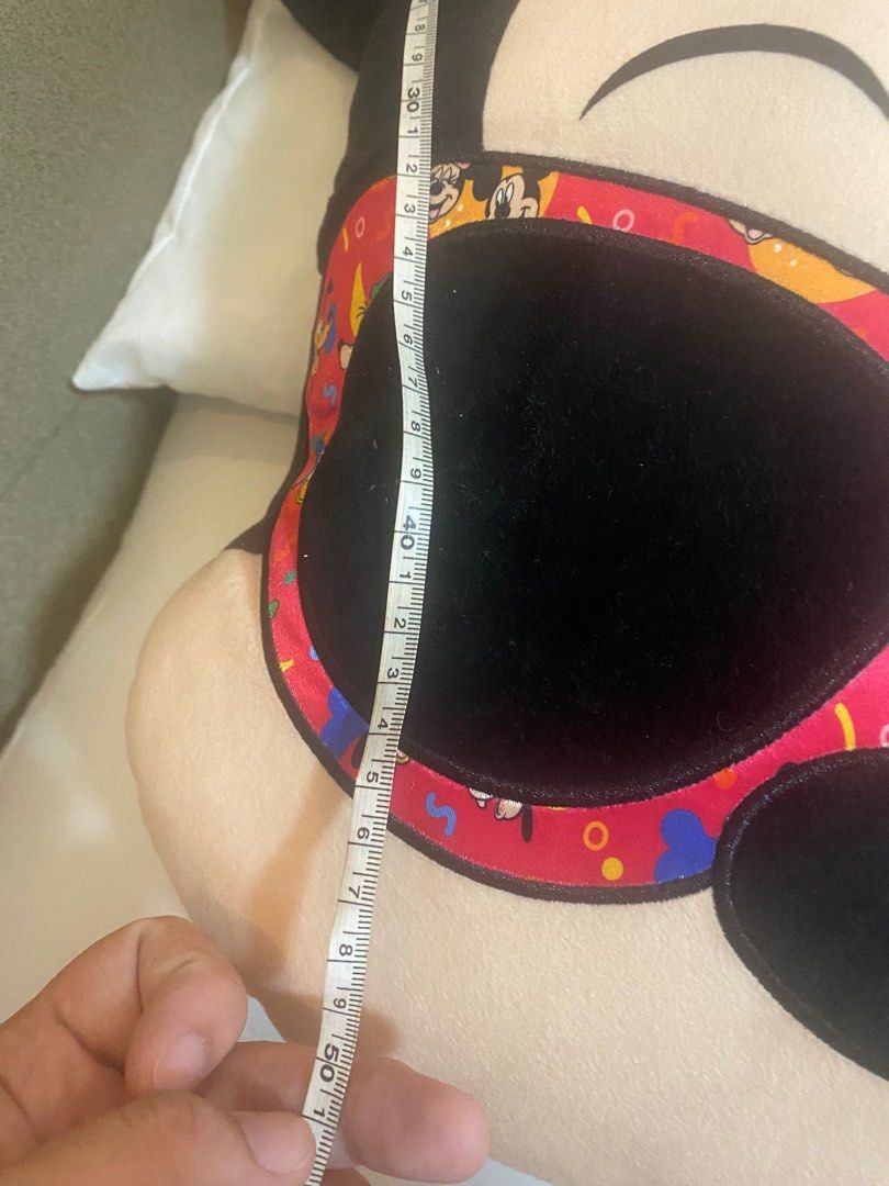 Minnie Mouse Plush Pillow (Category: Plushies & Soft Toys) located in Quezon City. Submitted by avyness (Listing ID 1405246578, Image 2). Description: - Mickey Mouse plush pillow - Features Mickey's face with sunglasses - Red patterned border - Approximately 50cm in height - Perfect for Disney enthusiasts or decor.