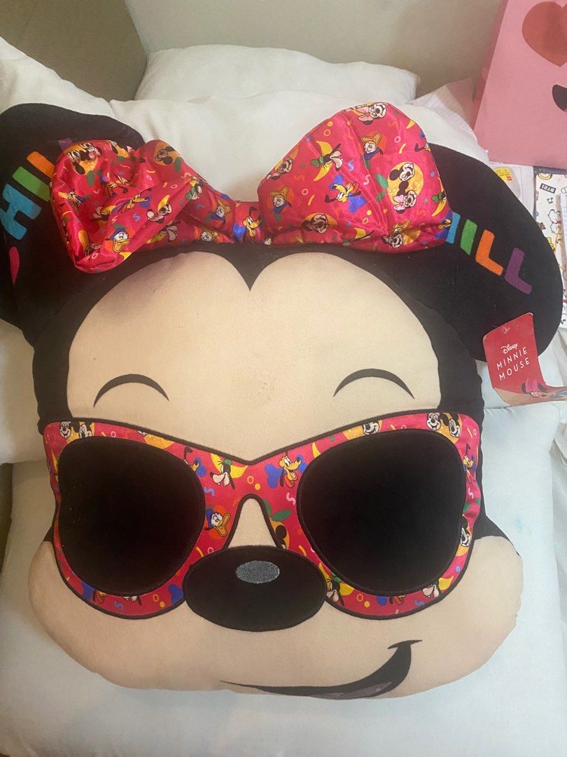 Minnie Mouse Plush Pillow (Category: Plushies & Soft Toys) located in Quezon City. Submitted by avyness (Listing ID 1405246578, Image 1). Description: - Mickey Mouse plush pillow - Features Mickey's face with sunglasses - Red patterned border - Approximately 50cm in height - Perfect for Disney enthusiasts or decor.