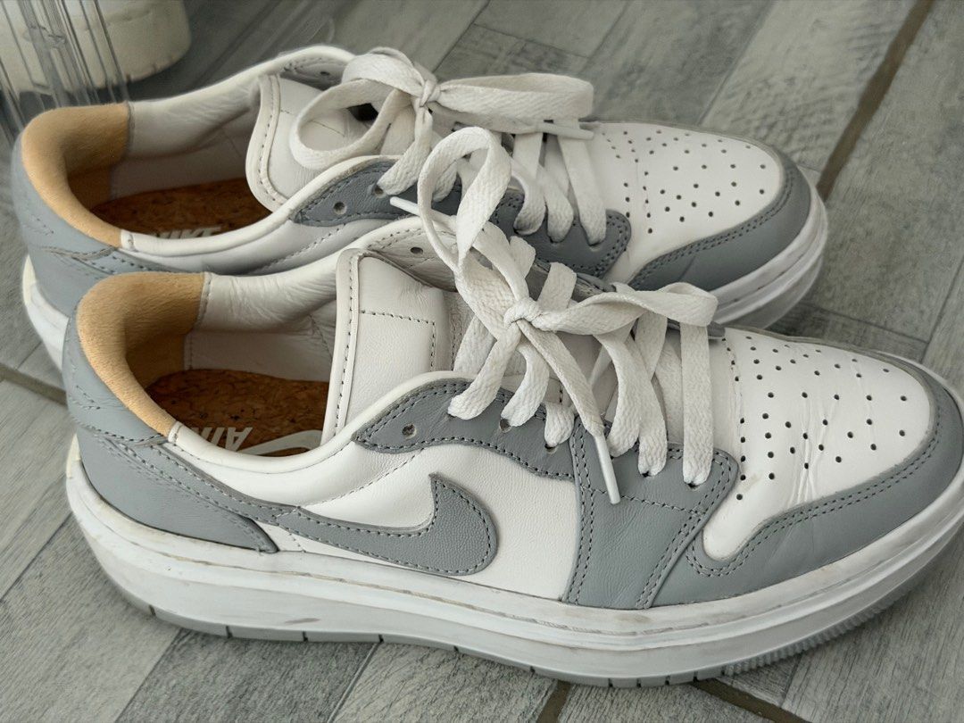 Nike Air Jordan 1 Low Elevate Wolf Grey (W) (Category: Sneakers) located in Antipolo. Submitted by feifeitep (Listing ID 1405191224, Image 3). Description: - Nike Air Jordan 1 Low Elevate US 7.5 - Color: Wolf Grey (White and Grey) - Design: Perforated toe box, thick sole - Details: Nike Air logo on tongue, white laces, grey swoosh - Insole: Cork-like material - RFS: decluttering - NO BOX just shoes.