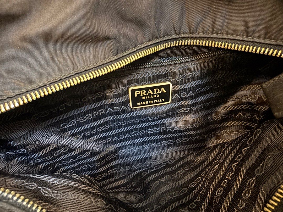 Prada Black Nylon Tote Bag with Chain Straps (Category: Luxury Bags & Wallets) located in Manila. Submitted by kjbsb_041 (Listing ID 1405164094, Image 2). Description: - Authentic Prada tote bag - Black nylon exterior - Gold-tone chain straps with leather detailing - Prada logo on the front - Zipper closure - Tote style With minimal Flaws on the exterior. No other inclusions. Location: Taytay Rizal. MOP: BDO, BPI only. .