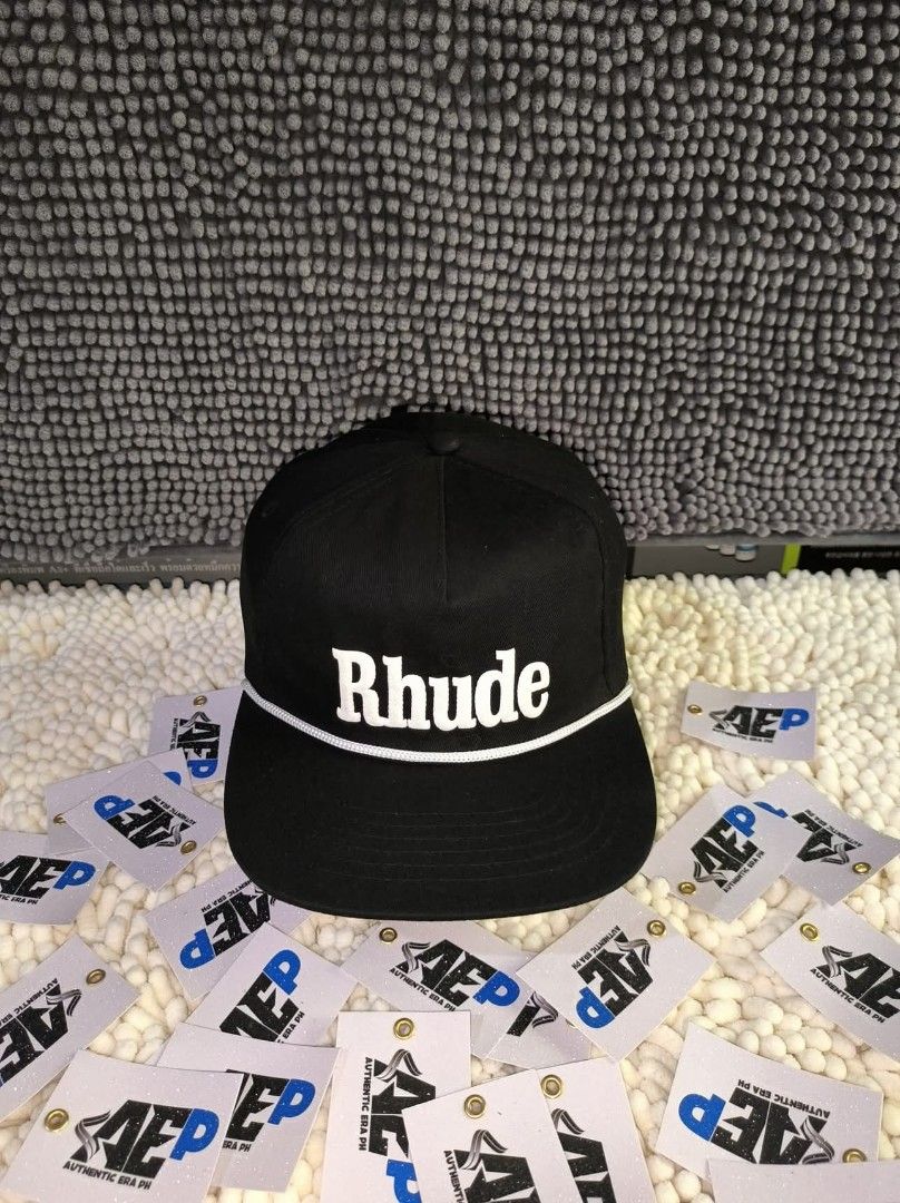 Rhude Caps made in USA (Category: Caps & Hats) located in San Jose del Monte. Submitted by authenticeraph (Listing ID 1405270092, Image 1). Description: - Black Rhude caps - Available designs: - White brand name - Green and gold logo - Red and gold emblem - Flat-brimmed.
