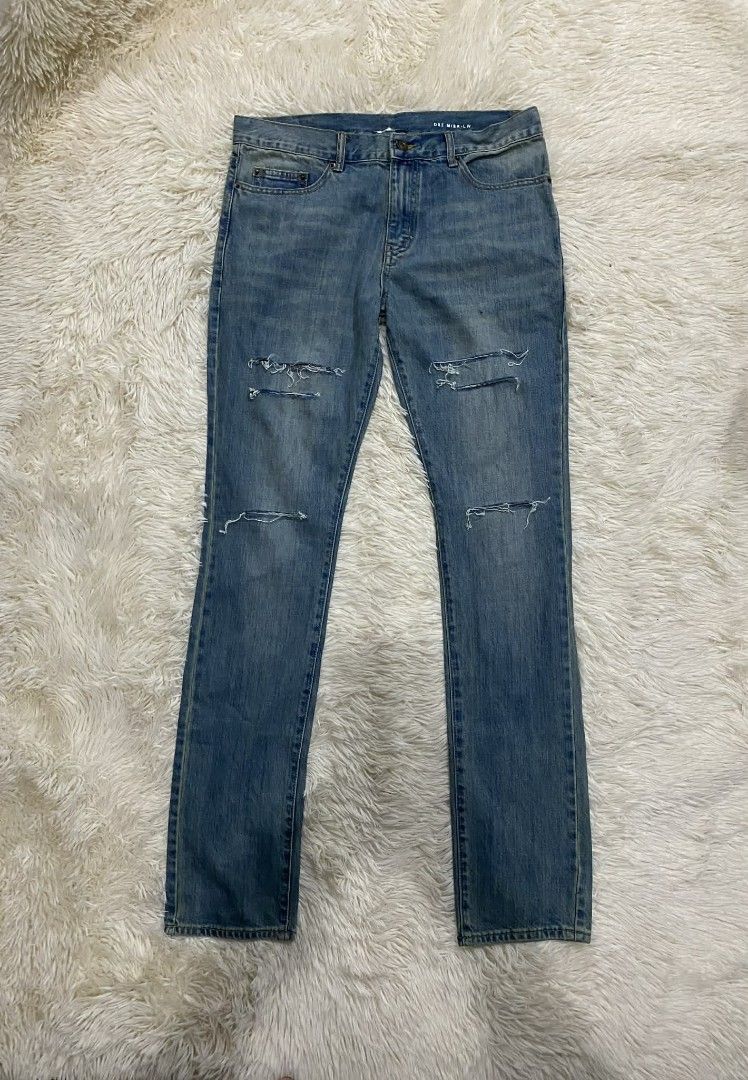 Saint Laurent Distressed Jeans (Category: Luxury Apparel) located in Manila. Submitted by switchcity (Listing ID 1405344562, Image 1). Description: - Saint Laurent Paris jeans - Distressed details - Light wash denim - Slim fit -SIZE 34 - Classic five-pocket design - Button closure with Saint Laurent Paris logo - Size: 002 M/SK/LW.