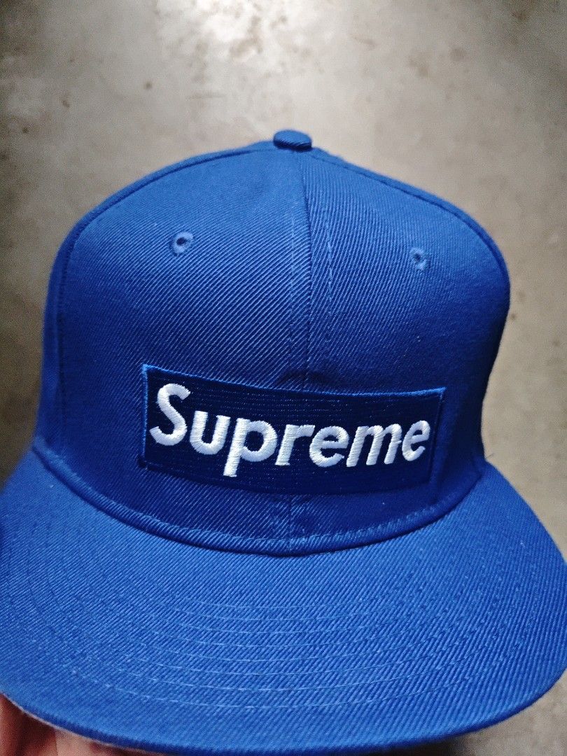 Supreme New Era Cap (Category: Caps & Hats) located in San Jose del Monte. Submitted by authenticeraph (Listing ID 1405237755, Image 2). Description: - Supreme blue cap - Features the iconic Supreme box logo - New Era 59FIFTY - Size: 7 1/4 - Made of 80% acrylic, 20% wool - Includes Supreme and New Era tags.