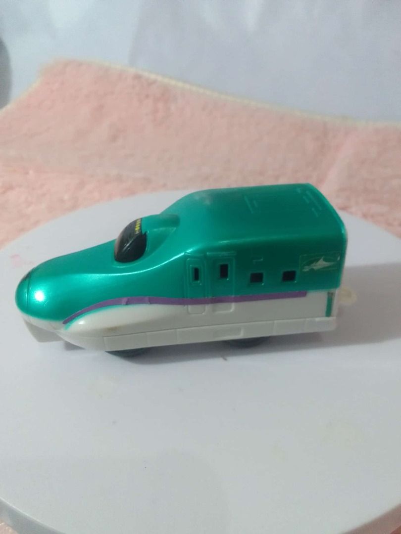 Toy Train Assortment Take all (Category: Vehicle & Diecast Models) located in Tanza. Submitted by leonskidskorner (Listing ID 1405276233, Image 3). Description: Collection of toy trains in various colors and designs. Includes a black train, a green train, a red train, and several bullet train models. Some trains have pull-back mechanisms. Great for kids who love trains or collectors..