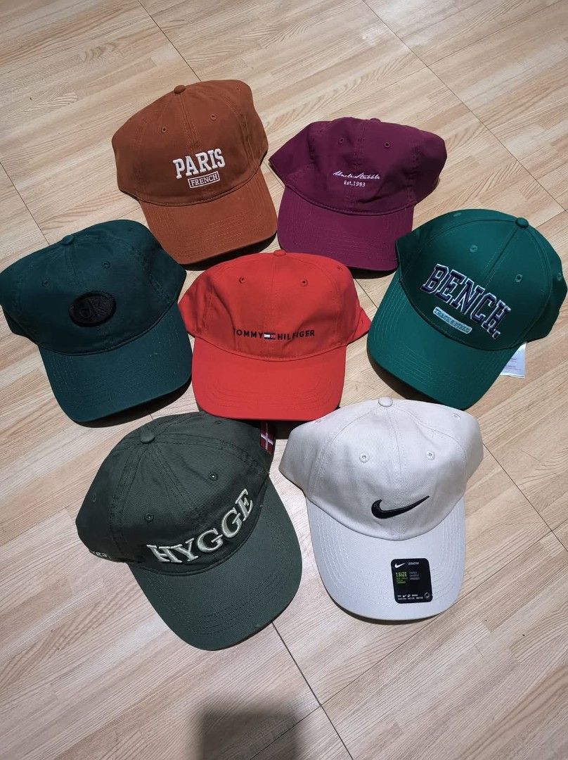 Assorted Caps (Category: Caps & Hats) located in San Jose del Monte. Submitted by authenticeraph (Listing ID 1405463272, Image 1). Description: Collection of caps in various colors and designs. Includes caps with "PARIS", "Tommy Hilfiger", "Bench", "HYGGE", and Nike logos. Colors include brown, maroon, green, red, and white. Perfect for adding a stylish touch to any outfit..