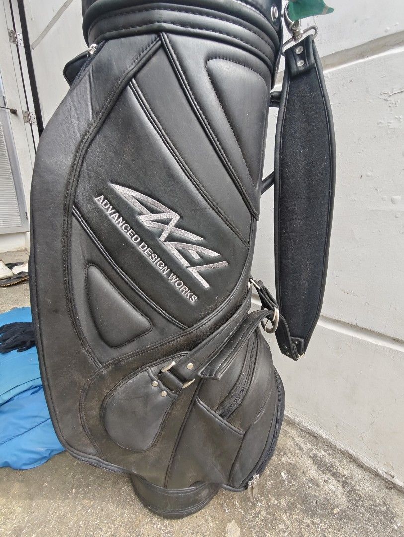 Axel Advanced Design Works Golf Bag (Category: Golf) located in Manila. Submitted by babz30261 (Listing ID 1405400888, Image 2). Description: - Black Axel Advanced Design Works golf bag - Multiple compartments for storage - Comfortable shoulder strap - Includes a zippered pocket - Features a decorative tag - Made of leather.