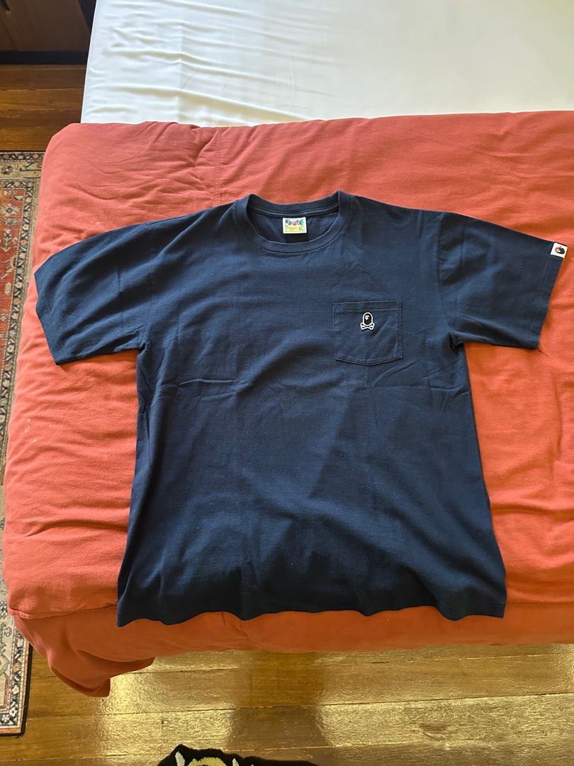 BAPE Pirate Skull Pocket Tee XL (Category: Tshirts & Polo Shirts ) located in Paranaque City. Submitted by mrbentables (Listing ID 1405527652, Image 1). Description: - Navy blue BAPE t-shirt - Size: XL - Design: Skull pocket - Features BAPE logo on neck tag and sleeve - Material: 100% cotton - Style: Crew neck, short sleeves.