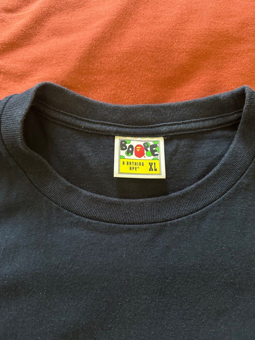 BAPE Pirate Skull Pocket Tee XL (Category: Tshirts & Polo Shirts ) located in Paranaque City. Submitted by mrbentables (Listing ID 1405527652, Image 3). Description: - Navy blue BAPE t-shirt - Size: XL - Design: Skull pocket - Features BAPE logo on neck tag and sleeve - Material: 100% cotton - Style: Crew neck, short sleeves.
