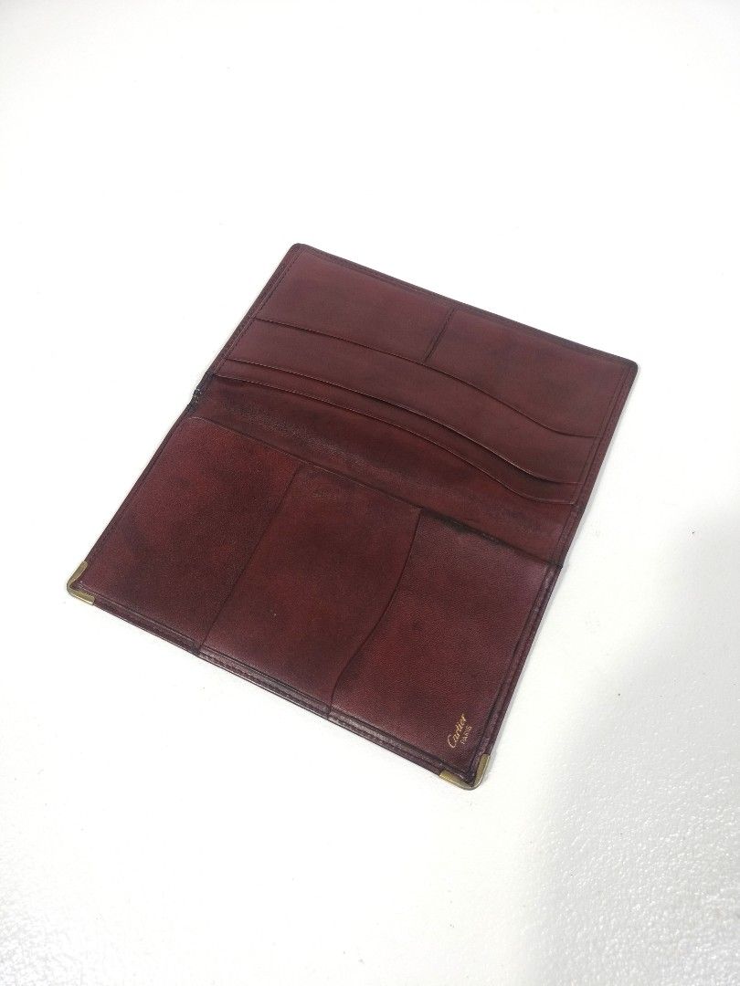 Cartier Leather Wallet (Category: Luxury Bags & Wallets) located in Manila. Submitted by callmetin (Listing ID 1405507591, Image 3). Description: - Authentic Cartier wallet - Rich burgundy leather - Multiple card slots - Bill compartment - Subtle Cartier logo embossing - Gold-toned metal corner reinforcements - Crafted from high-quality leather.