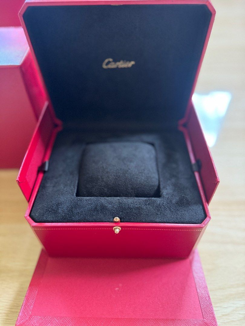 Cartier Watch Box (Category: Luxury Watches) located in Quezon City. Submitted by tag42 (Listing ID 1405353493, Image 1). Description: - Authentic Cartier watch box - Red exterior - Gold-colored clasp - Black fabric interior - Includes watch pillow - Comes with outer box - Cartier logo visible.