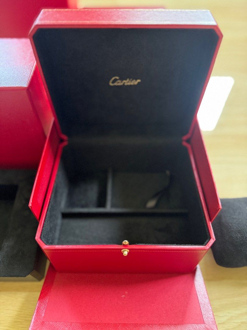 Cartier Watch Box (Category: Luxury Watches) located in Quezon City. Submitted by tag42 (Listing ID 1405353493, Image 2). Description: - Authentic Cartier watch box - Red exterior - Gold-colored clasp - Black fabric interior - Includes watch pillow - Comes with outer box - Cartier logo visible.