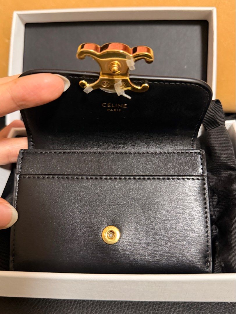 Authentic Celine Triomphe Card Holder/Wallet (Category: Luxury Bags & Wallets) located in Quezon City. Submitted by kmaeb (Listing ID 1405512493, Image 3). Description: - Celine Triomphe card holder - Black smooth leather exterior - Black leather interior - Gold-tone Triomphe clasp closure - Multiple card slots - Snap closure - Includes original box and dustbag.
