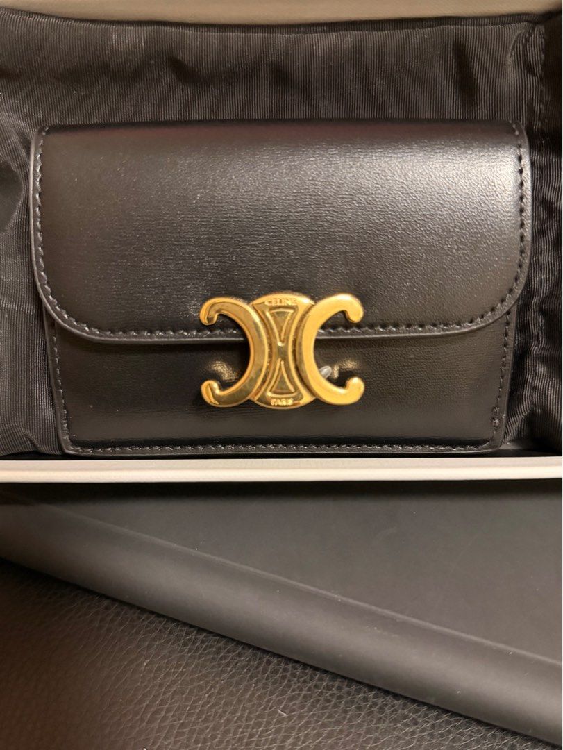 Authentic Celine Triomphe Card Holder/Wallet (Category: Luxury Bags & Wallets) located in Quezon City. Submitted by kmaeb (Listing ID 1405512493, Image 1). Description: - Celine Triomphe card holder - Black smooth leather exterior - Black leather interior - Gold-tone Triomphe clasp closure - Multiple card slots - Snap closure - Includes original box and dustbag.