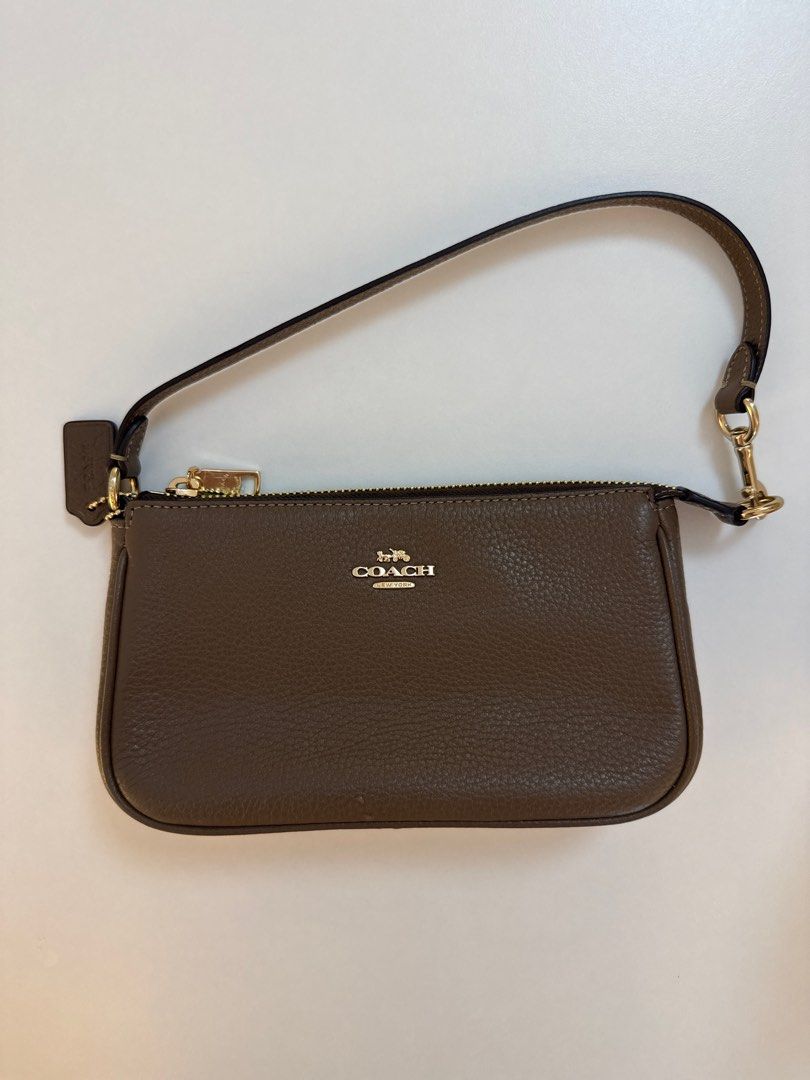 Coach Wristlet in Dark Stone (Category: Wallets & Card holders) located in Taguig. Submitted by kaiatphnow (Listing ID 1405383571, Image 1). Description: - Coach wristlet in dark stone - Zip closure - Wrist strap - Coach logo on front - Includes original tags - Style: NLT 19 PBL LTH.