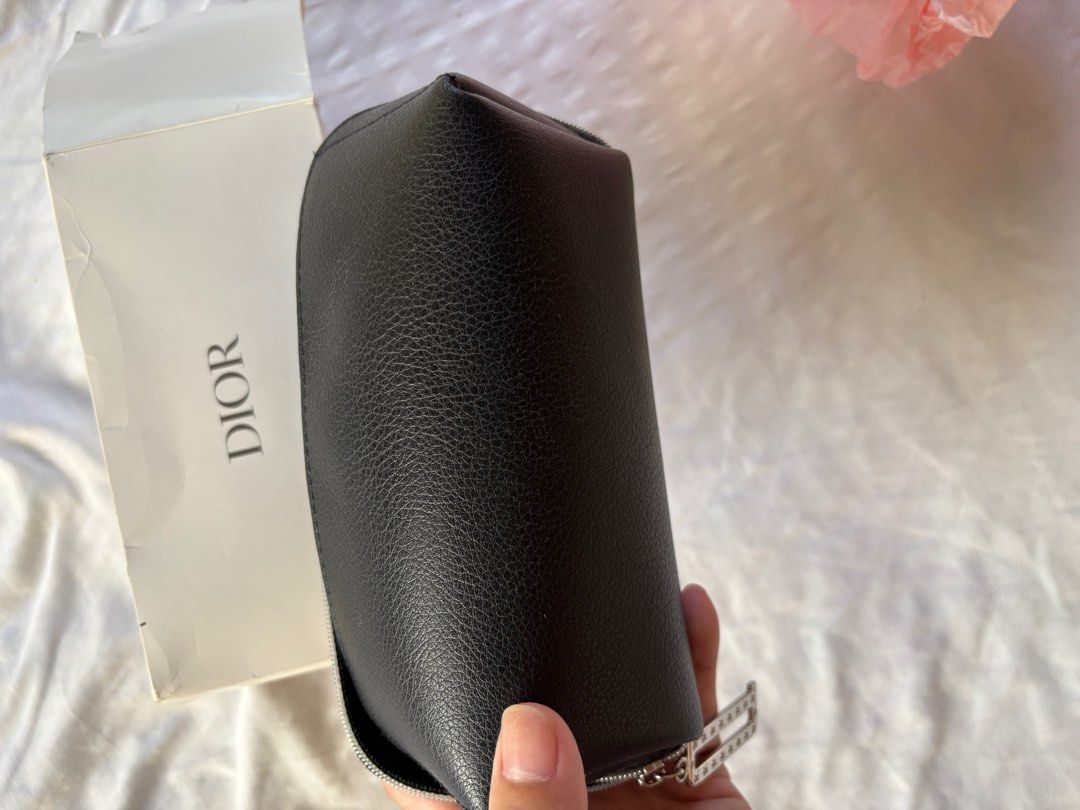 Dior Black Cosmetic Pouch (Category: Luxury Bags & Wallets) located in Tarlac. Submitted by vectorreyes (Listing ID 1405404807, Image 3). Description: - Authentic Dior cosmetic pouch -coded - Black color - Zip closure - Dior logo embossed on front - Clear interior lining with star patterns - Unique shape - Silver zipper - Includes original Dior box -GWP gift for VIP Client with qualifying purchases .