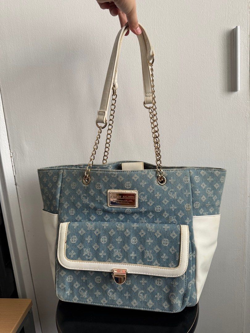 Esfolio Denim Tote Bag with Chain Straps (Category: Tote Bags) located in Las Pinas. Submitted by MrsBii (Listing ID 1405421605, Image 3). Description: - Esfolio denim tote bag - Unique pattern and white accents - Chain straps - Front pocket - Spacious interior with zippered pocket - Magnetic closure - Versatile for everyday use.