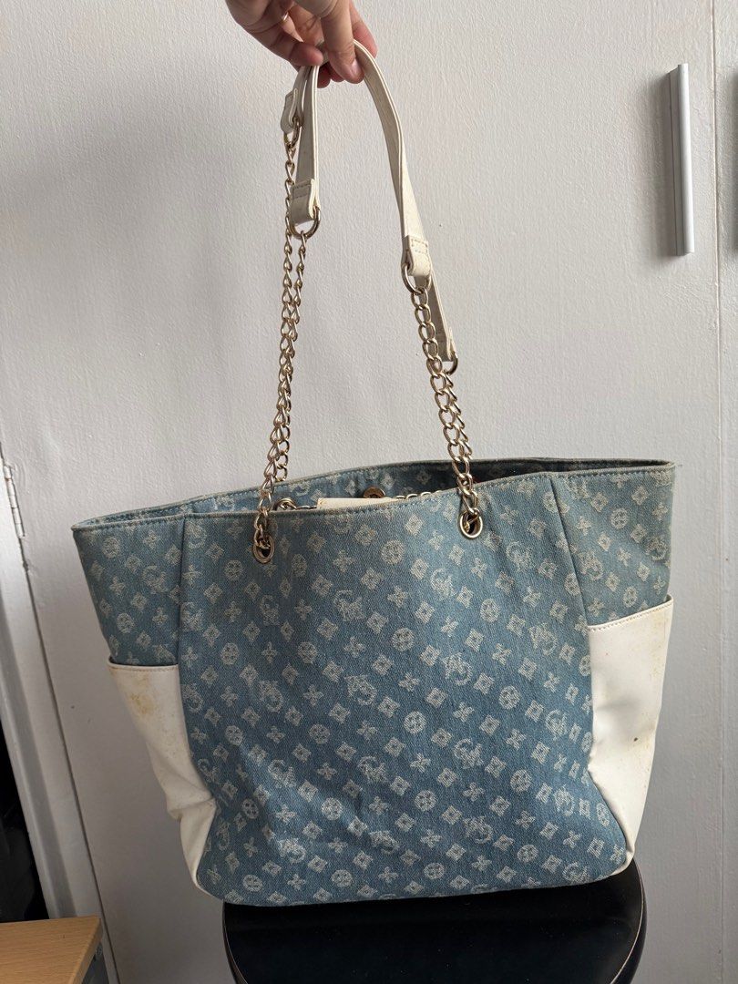Esfolio Denim Tote Bag with Chain Straps (Category: Tote Bags) located in Las Pinas. Submitted by MrsBii (Listing ID 1405421605, Image 2). Description: - Esfolio denim tote bag - Unique pattern and white accents - Chain straps - Front pocket - Spacious interior with zippered pocket - Magnetic closure - Versatile for everyday use.
