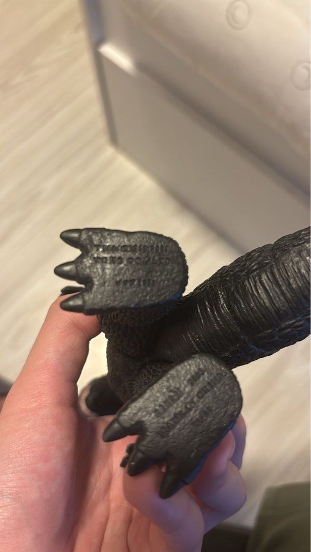 Godzilla Sofubi Original (Category: Toys & Games) located in Petaling Jaya. Submitted by shikikanjoshustore (Listing ID 1405400702, Image 3). Description: - Classic Godzilla collectible figure. - Features detailed design with dorsal fins and textured body. - Made of durable black plastic. - Text imprinted on feet. - Ideal for Godzilla fans and toy collectors..