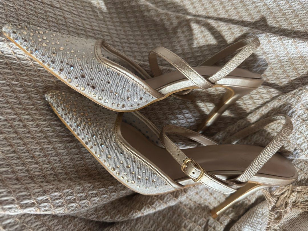 Gold Embellished Heels with Ankle Strap (Category: Heels) located in Las Pinas. Submitted by lifem (Listing ID 1405427498, Image 1). Description: - Gold heels - Pointed toe - Sparkling embellishments - Ankle strap with buckle - Slender heel - Great for special events Looks new. One time lang nagamit.