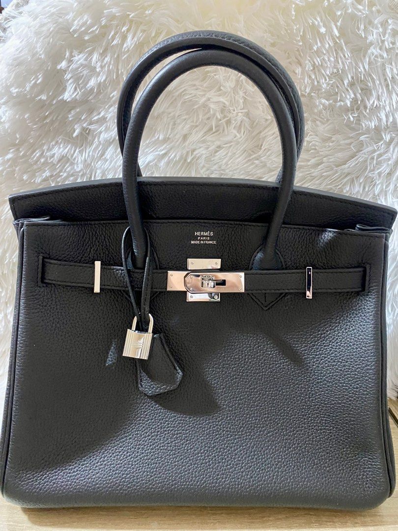 Hermès Black Leather Handbag (Category: Luxury Bags & Wallets) located in Las Pinas. Submitted by shaina1111 (Listing ID 1405392036, Image 1). Description: - Black leather handbag - Silver-tone clasp and hardware - Includes padlock and key - Double handles - Structured shape - Brand name visible - Made in France.