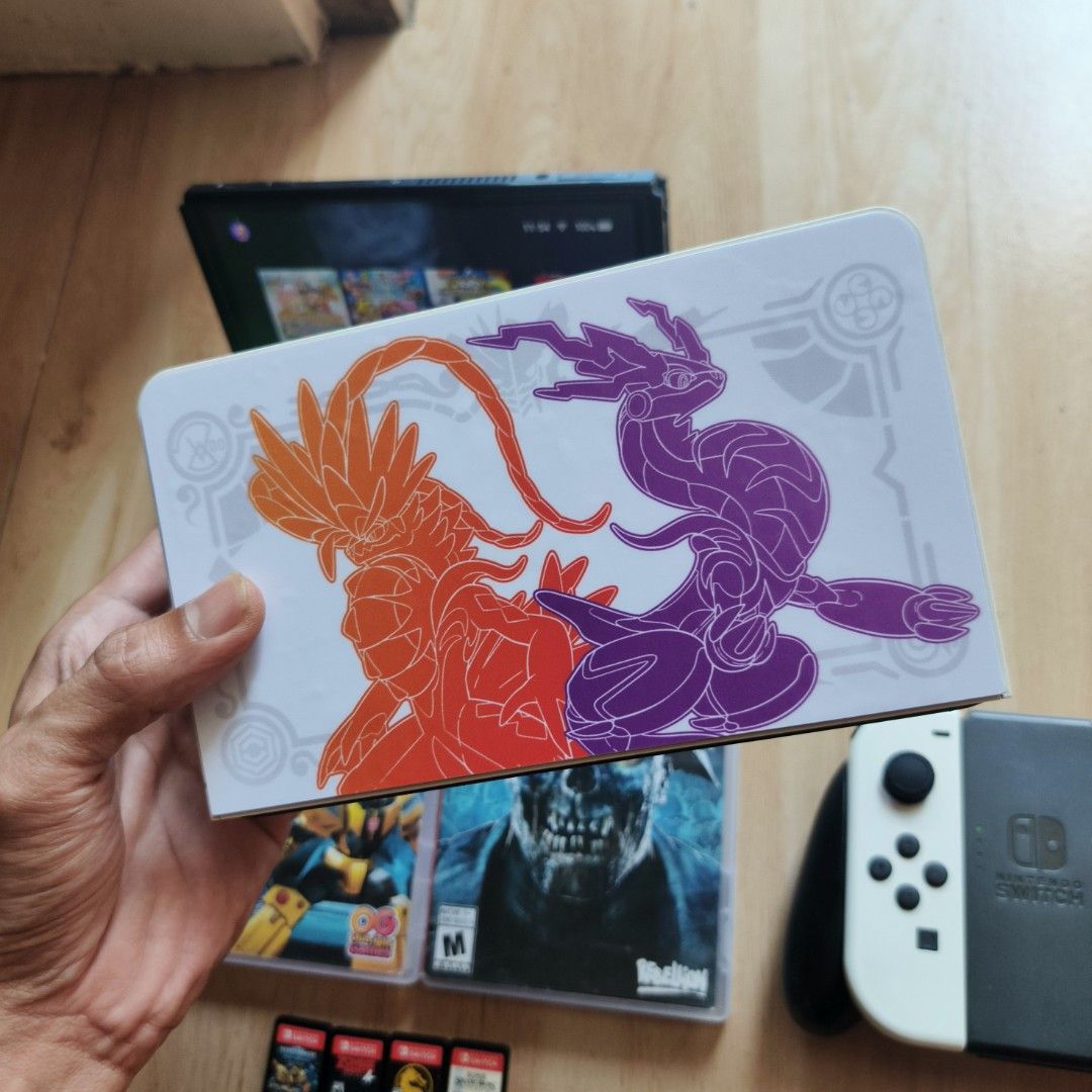 Nintendo Switch Oled (Category: Nintendo) located in Banga. Submitted by lsegadgets (Listing ID 1405374978, Image 3). Description: - Nintendo Switch OLED (Pokemon Scarlet/Violet design Sticker only - Includes console, dock, and white Joy-Cons - Comes with: - Transformers Earthspark Expedition game cartridge - Zombie Army 4 Dead War game cartridge - MORTAL COMBAT -SSBU - Ready to play! SEMI COMPLETE ACCESSORIES NO BOX. P13500 LBC. LOC.. SOUTH.