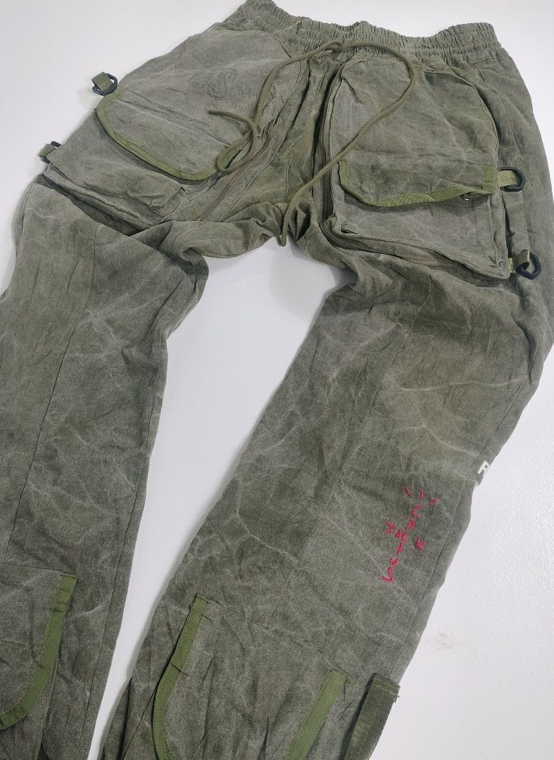 Readymade Track Pants Cacktus Jack (Category: Joggers) located in Manila. Submitted by callmetin (Listing ID 1405507713, Image 3). Description: Readymade track pants in size 3. Features multiple pockets, including cargo pockets with tiger stripe camouflage lining. Includes a drawstring waist and zippers. The pants have "READYMADE" printed on the side and a pink embroidered design. Made from vintage cotton Condition : Verygood Size : 3 Actual 👇 W