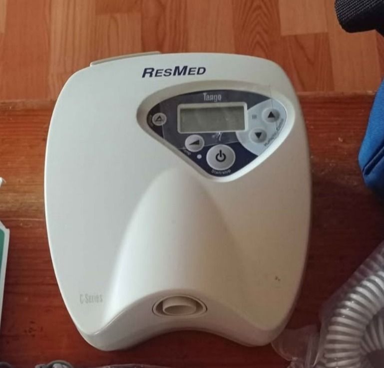 ResResMed Tango CPAP Machine with Accessories (Category: Medical Supplies & Tools) located in Baguio. Submitted by sibvirgy40652 (Listing ID 1405375588, Image 1). Description: ResMed Trilage CPAP machine with various accessories, including a nasal pillow interface, tubing, power cables, and a carrying bag. The machine has a digital display and control buttons. The included bag is blue with the ResMed logo. Additional accessories are also included