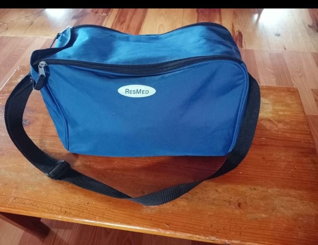 ResResMed Tango CPAP Machine with Accessories (Category: Medical Supplies & Tools) located in Baguio. Submitted by sibvirgy40652 (Listing ID 1405375588, Image 3). Description: ResMed Trilage CPAP machine with various accessories, including a nasal pillow interface, tubing, power cables, and a carrying bag. The machine has a digital display and control buttons. The included bag is blue with the ResMed logo. Additional accessories are also included